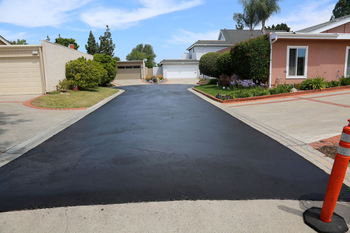 Freshly paved asphalt driveway in Carlsbad.